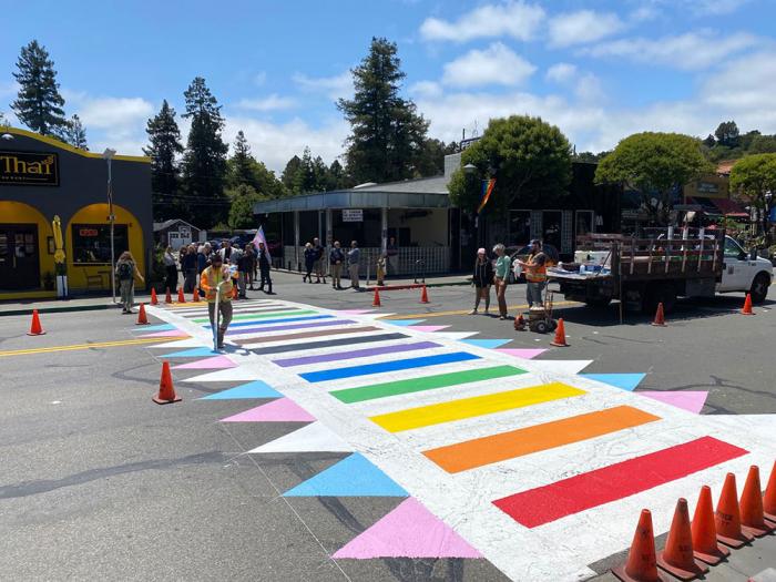 Workers in the Marin County town of Fairfax in May put the finishing touches on a Progress Pride rainbow crosswalk between the Parkade and My Thai restaurant to celebrate LGBTQ+ Pride. Photo: Courtesy Town of Fairfax