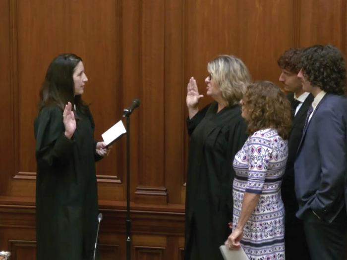 California Supreme Court Chief Justice Patricia Guerrero, left, administers the oath of office to Third District Court of Appeal Presiding Justice Laurie Earl, who was joined by her wife and their two sons. Photo: Screengrab via court website