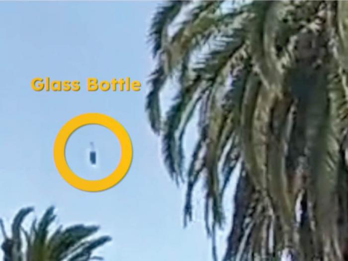 San Francisco Police Chief William Scott showed video that included a glass bottle, circled, being hurled at police from Dolores Street during the July 8 hill bomb event. Photo: Screengrab via SFGovTV