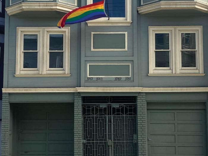 The rainbow flag flying at a Castro apartment building may be replaced with a smaller Progress Pride flag. Photo: Henry Walker