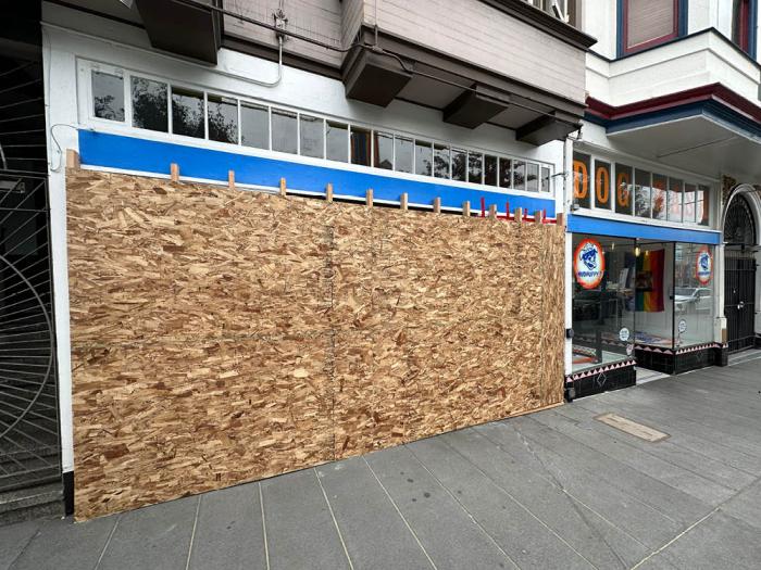 A window of Mudpuppy's was boarded up Monday after an alleged drunken driver crashed into the building. Photo: John Ferrannini