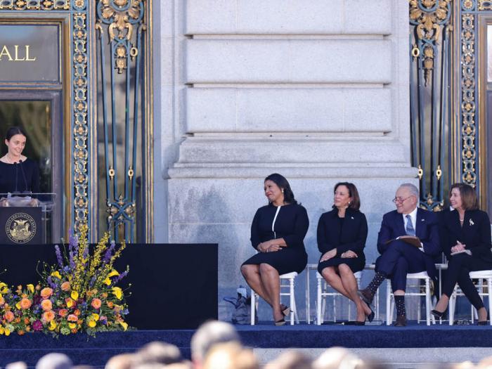 Eileen Mariano, left, speaks at the memorial service for her grandmother, senator Dianne Feinstein, October 5 outside San Francisco City Hall. Looking on are Mayor London Breed, Vice President Kamala Harris, Senate Majority Leader Chuck Schumer, and Congressmember Nancy Pelosi. Photo: SF Chronicle pool<br> 