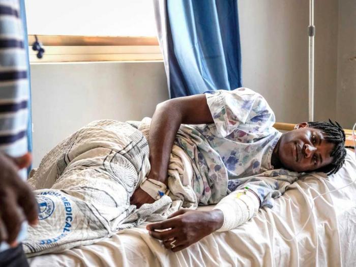 Ugandan LGBTQ activist Steven Kabuye is treated at a hospital near Kampala on January 4 after he was attacked by unknown people. Photo: Hajarah Nalwadda/AP<br>