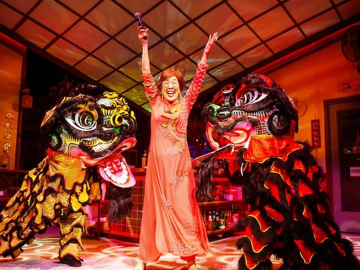 Lan (Sharon Omi - center) celebrates the new year with lion dancers (left - Erin Mei-Ling Stuart, right- Will Dao) in San Francisco Playhouse's 'My Home on the Moon' (photo: Jessica Palopoli)