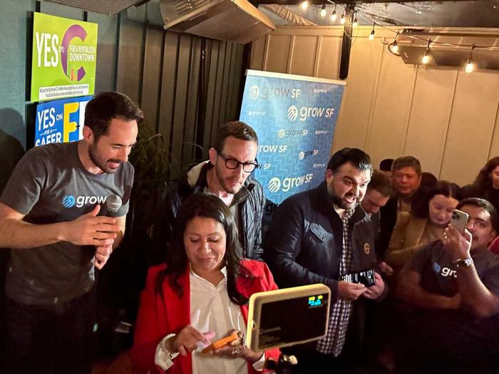 Steven Buss, left, joined Mayor London Breed, center, and state Senator Scott Wiener in looking at early election returns Tuesday night at Anina in Hayes Valley. Photo: John Ferrannini