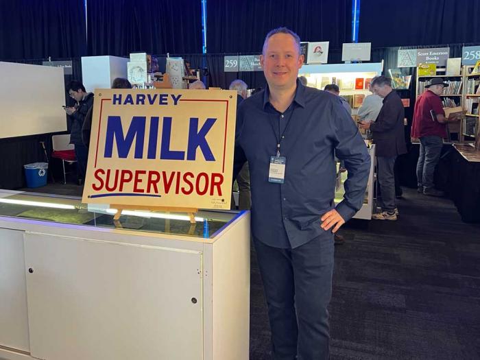 Douglas Stewart stands next to his poster for Harvey Milk's 1975 campaign for San Francisco supervisor at the California Antiquarian Book Fair, held last month in the city. Photo: Matthew S. Bajko