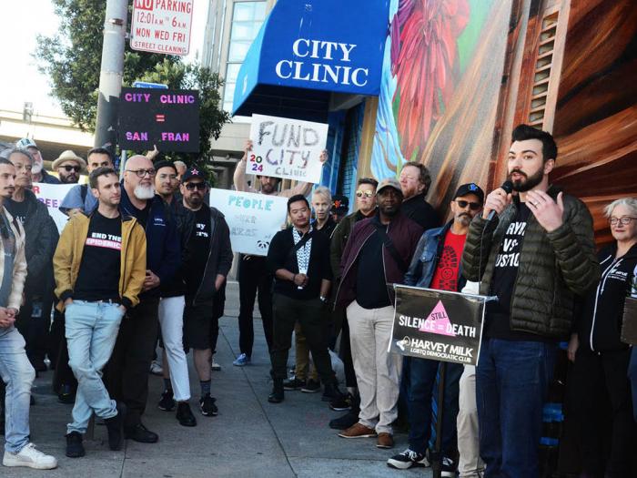 Edward Wright, right, from the Harvey Milk LGBTQ Democratic Club, spoke at a May 2 rally to demand that funds for City Clinic be included in the mayor's fall bond measure. Photo: Rick Gerharter
